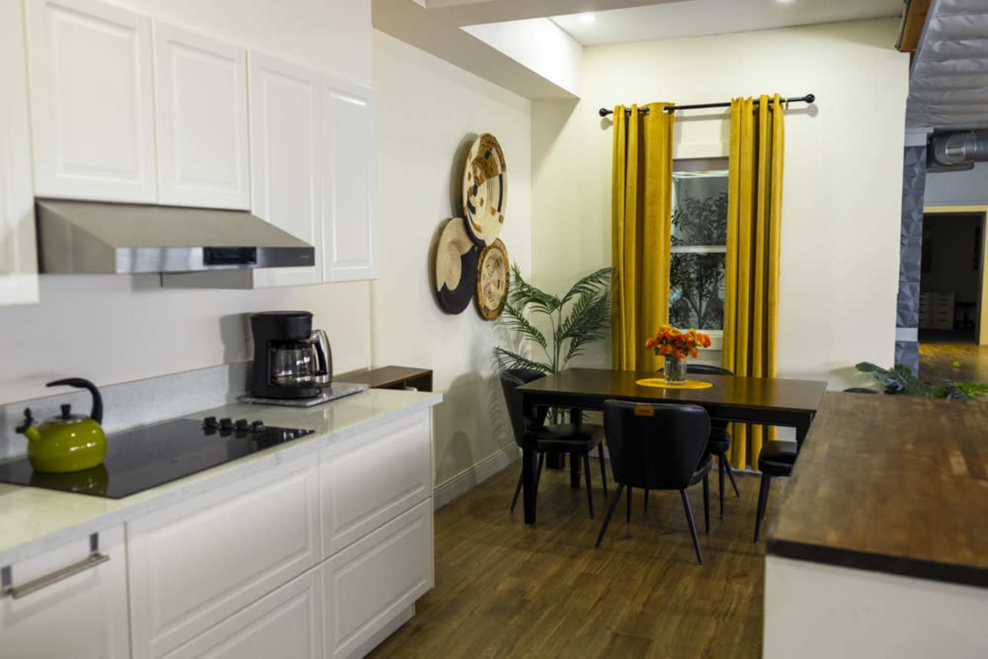 Kitchen setup with white cabinets and dining nook