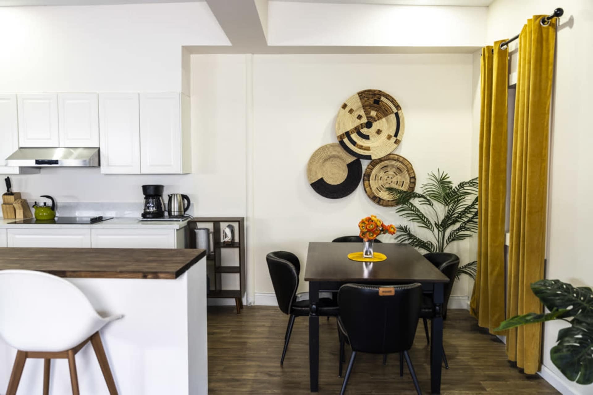 Dining area with wood table and yellow curtains