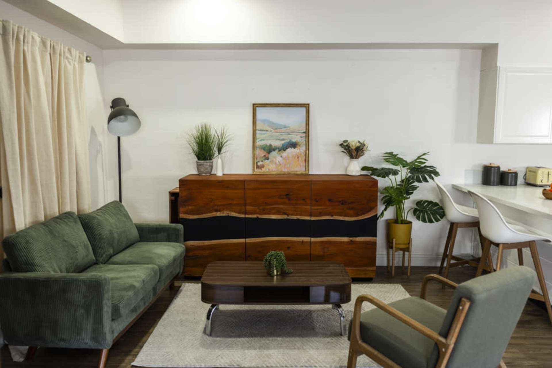 Cozy living room with green sofas and plants