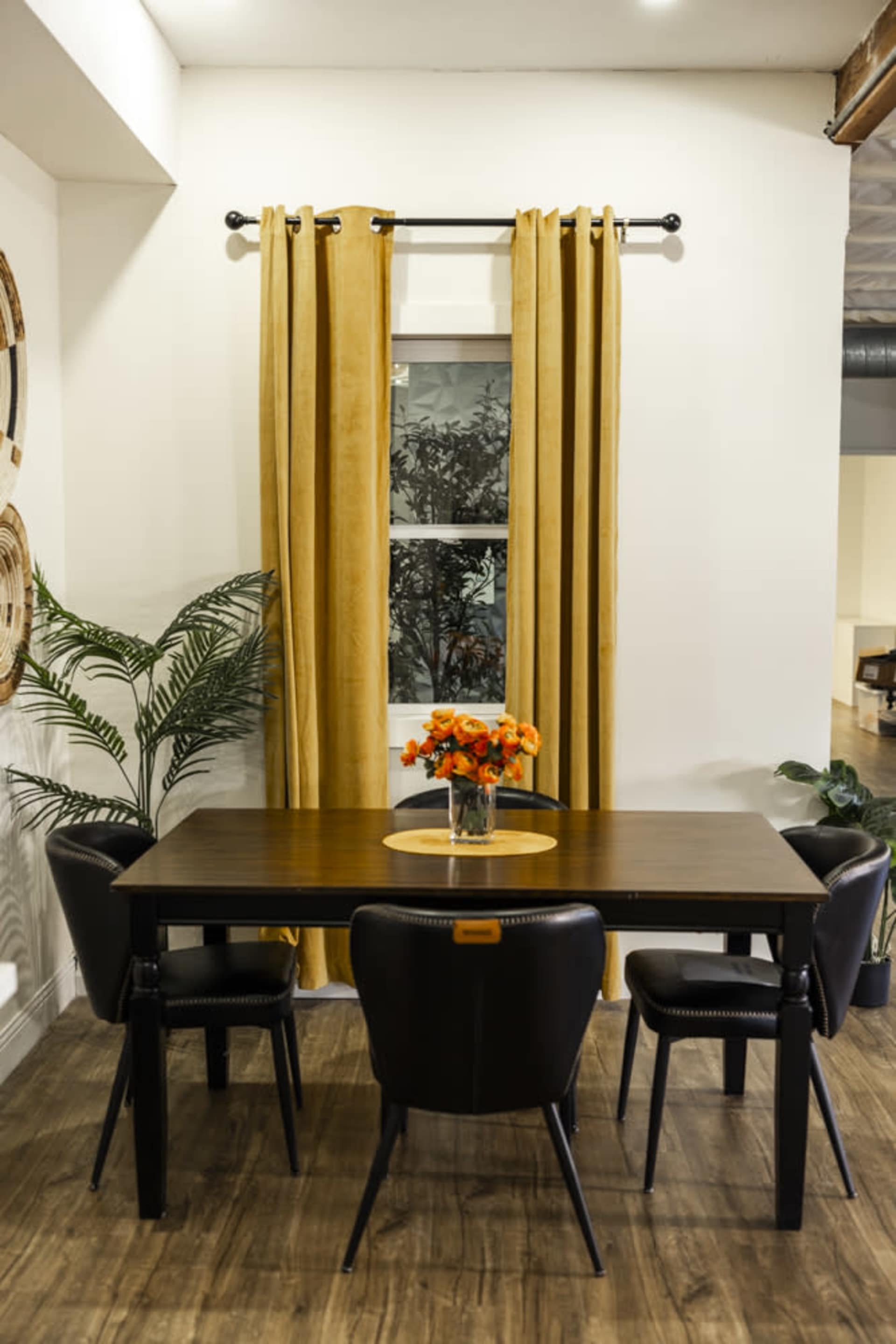 Dining table with black chairs by the window